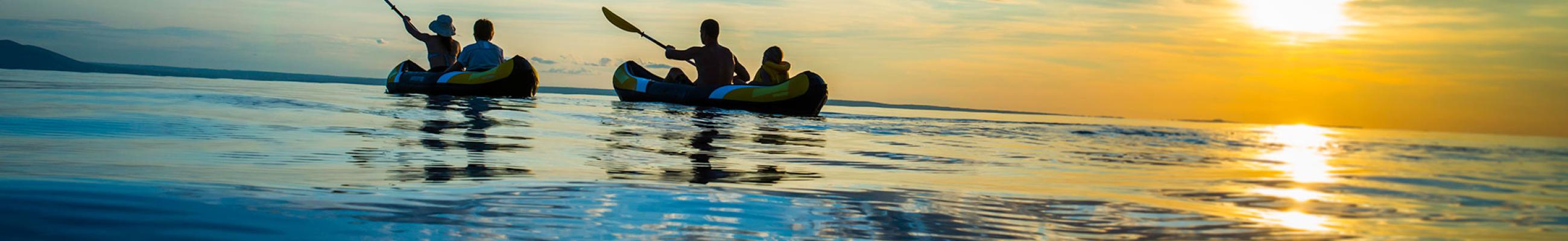 Family canoeing at sunset